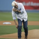 Hall of Fame thoroughbred trainer and Triple Crown winner Bob Baffert jokingly grabs his shoulder after throwing the ceremonial first pitch before a baseball game between the Los Angeles Dodgers and the Arizona Diamondbacks, Tuesday, June 9, 2015, in Los Angeles. (AP Photo/Jae C. Hong)