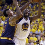 Golden State Warriors forward Draymond Green (23) shoots against Cleveland Cavaliers guard J.R. Smith (5) during the second half of Game 1 of basketball's NBA Finals in Oakland, Calif., Thursday, June 4, 2015. (AP Photo/Ben Margot)