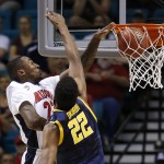 Arizona's Rondae Hollis-Jefferson, left, dunks over California's Kingsley Okoroh in the first half of an NCAA college basketball game in in the quarterfinals of the Pac-12 conference tournament Thursday, March 12, 2015, in Las Vegas. (AP Photo/John Locher)
