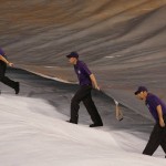 Field guards pull the tarpaulin off the diamond of Coors Field after a heavy storm dumped rain and hail before the first inning of a baseball game between the Arizona Diamondbacks and Colorado Rockies Wednesday, June 24, 2015, in Denver. (AP Photo/David Zalubowski)