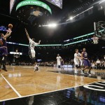Phoenix Suns' Marcus Morris (15) shoots over Brooklyn Nets' Thaddeus Young (30) during the first half of an NBA basketball game Friday, March 6, 2015, in New York. (AP Photo/Frank Franklin II)
