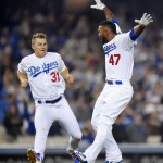 Los Angeles Dodgers' Howie Kendrick, right, celebrates his walk off single that scored Yasiel Puig with Joc Pederson in the ninth inning of a baseball game against the Arizona Diamondbacks, Wednesday, June 10, 2015, in Los Angeles. (AP Photo/Mark J. Terrill)