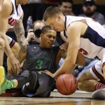 Arizona's Kaleb Tarczewski, right, and Oregon's Joseph Young battle for the ball during the second half of an NCAA college basketball game in the championship of the Pac-12 conference tournament Saturday, March 14, 2015, in Las Vegas. Arizona won 80-52. (AP Photo/John Locher)