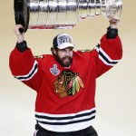 Chicago Blackhawks' goalie Corey Crawford hoists the Stanley Cup trophy after defeating the Tampa Bay Lightning in Game 6 of the NHL hockey Stanley Cup Final series on Wednesday, June 10, 2015, in Chicago. The Blackhawks defeated the Lightning 2-0 to win the series 4-2. (AP Photo/Charles Rex Arbogast)
