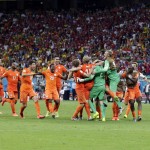 The Dutch team celebrates after the Netherlands defeated Costa Rica 4-3 in a penalty shootout after a 0-0 tie during the World Cup quarterfinal soccer match at the Arena Fonte Nova in Salvador, Brazil, Saturday, July 5, 2014. (AP Photo/Wong Maye-E)