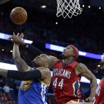 Golden State Warriors center Marreese Speights goes to the basket in front of New Orleans Pelicans' Dante Cunningham, center and Ryan Anderson during the first half of Game 3 of a first-round NBA basketball playoff series in New Orleans, Thursday, April 23, 2015. (AP Photo/Gerald Herbert)
