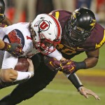 Utah's Travis Wilson (7) gets tackled by Arizona State's Kweishi Brown, right, in the first half of an NCAA college football game on Saturday, Nov. 1, 2014, in Tempe, Ariz. (Photo/Ross D. Franklin)