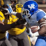 Kentucky running back Stanley Williams, right, stiff arms Missouri's Braylon Webb as he runs during the first quarter of an NCAA college football game Saturday, Nov. 1, 2014, in Columbia, Mo. (AP Photo/L.G. Patterson)