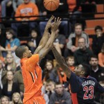 Oregon State guard Gary Payton II, left, shoots over Arizona forward Rondae Hollis-Jefferson during the first half of an NCAA college basketball game in Corvallis, Ore., Sunday, Jan. 11, 2015. (AP Photo/Don Ryan)
