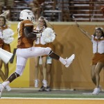 Texas' Demarco Cobbs (7) high-steps into the end zone as he scores against North Texas on an interception return during the second half of an NCAA college football game, Saturday, Aug. 30, 2014, in Austin, Texas. Texas won 38-7. (AP Photo/Eric Gay)