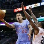 Los Angeles Clippers' Matt Barnes (22) drives past Phoenix Suns' Eric Bledsoe (2) during the first half of an NBA basketball game, Sunday, Jan. 25, 2015, in Phoenix. (AP Photo/Ross D. Franklin)