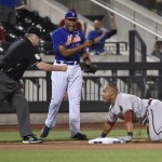 New York Mets pitcher Jeurys Familia reacts as umpire Bill Welke, left, calls Arizona Diamondbacks' Yasmany Tomas, right, out at third base during the ninth inning of a baseball game Friday, July 10, 2015, in New York. The call was reversed to safe after a manager's challenge. (AP Photo/Bill Kostroun)
