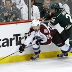 Colorado Avalanche right wing Marc-Andre Cliche (24) and Minnesota Wild left wing Matt Moulson (26) chase the puck during the first period of Game 3 of an NHL hockey first-round playoff series in St. Paul, Minn., Monday, April 21, 2014. (AP Photo/Ann Heisenfelt)
