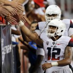 Arizona quarterback Anu Solomon (12) celebrates with fans after defeating California 49-45 on a game winning hail mary touchdown with no time on the clock during an NCAA college football game, Saturday, Sept. 20, 2014, in Tucson, Ariz. (AP Photo/Rick Scuteri)