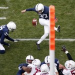 Penn State kicker Sam Ficken (97) kicks a 29-yard field goal out of the hold of Chris Gulla (37) during the first quarter of an NCAA college football game against Temple in State College, Pa., Saturday, Nov. 15, 2014. (AP Photo/Gene J. Puskar) 