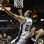 San Antonio Spurs guard Manu Ginobili (20) shoots over Miami Heat forward Chris Andersen during the first half in Game 2 of the NBA basketball finals on Sunday, June 8, 2014, in San Antonio. (AP Photo/Eric Gay)
