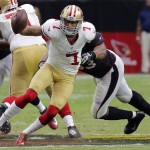 San Francisco 49ers quarterback Colin Kaepernick (7) is hit by Arizona Cardinals defensive end Calais Campbell (93) during the first half of an NFL football game, Sunday, Sept. 21, 2014, in Glendale, Ariz. (AP Photo/Rick Scuteri)