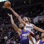 Portland Trail Blazers center Robin Lopez, right, reaches for a rebound over Phoenix Suns forward Marcus Morris during the second half of an NBA basketball game in Portland, Ore., Friday, April 4, 2014. Lopez scored 18 points as the Suns won 109-93. (AP Photo/Don Ryan)