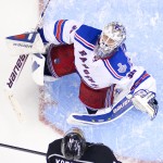  New York Rangers goalie Henrik Lundqvist, of Sweden, top, and Los Angeles Kings center Anze Kopitar, of Slovenia, the watches puck flip up in the during the third period in Game 1 of the NHL hockey Stanley Cup Finals, Wednesday, June 4, 2014, in Los Angeles. (AP Photo/Mark J. Terrill)