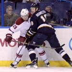 St. Louis Blues' Jay Bouwmeester (19) battles Arizona Coyotes' Lauri Korpikoski (28) for the lose puck in the first period of an NHL hockey game, Tuesday, Feb. 10, 2015, in St. Louis. (AP Photo/Tom Gannam)