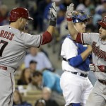  Arizona Diamondbacks' Miguel Montero, right, celebrates his home run past Los Angeles Dodgers catcher Tim Federowicz with Cody Ross during sixth inning of a baseball game in Los Angeles, Friday, April 18, 2014. (AP Photo/Chris Carlson)