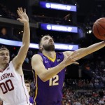 Albany's Peter Hooley (12), from Australia, shoots against Oklahoma's Ryan Spangler (00) in the second half of an NCAA tournament college basketball game in the Round of 64 in Columbus, Ohio, Friday, March 20, 2015. (AP Photo/Paul Vernon)