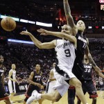 San Antonio Spurs guard Tony Parker (9) passes the ball away from Miami Heat forward Chris Andersen (11) during the first half in Game 2 of the NBA basketball finals on Sunday, June 8, 2014, in San Antonio. (AP Photo/Eric Gay)
