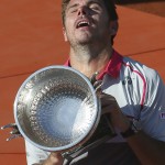 Switzerland's Stan Wawrinka holds the trophy after winning the men's final of the French Open tennis tournament in four sets, 4-6, 6-4, 6-3, 6-4, against Serbia's Novak Djokovic at the Roland Garros stadium, in Paris, France, Sunday, June 7, 2015. (AP Photo/David Vincent)

