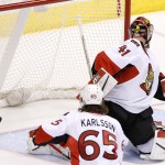 Ottawa Senators' Craig Anderson watches the puck get past him on a shot by the Arizona Coyotes during the second period of an NHL hockey game Saturday, Jan. 10, 2015, in Glendale, Ariz. The puck did not go into the net but instead it bounced around the front along the goal line. (AP Photo/Ross D. Franklin)