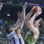 Dominican Republic's Eulis Baez, left, vies for the ball against Slovenia's Zoran Dragic, second right, during Basketball World Cup Round of 16 match between Dominican Republic and Slovenia at the Palau Sant Jordi in Barcelona, Spain, Saturday, Sept. 6, 2014. The 2014 Basketball World Cup competition will take place in various cities in Spain from Aug. 30 through to Sept. 14. (AP Photo/Manu Fernandez)