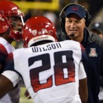 Arizona head coach Rich Rodriguez celebrates with running back Nick Wilson (28) after Wilson scored a touchdown during the third quarter of the NCAA college football game against Oregon at Autzen Stadium on Thursday, Oct. 2, 2014, in Eugene, Ore. Arizona won the game 31-24. (AP Photo/Steve Dykes)