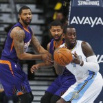 Denver Nuggets forward J.J. Hickson, right, pulls in a loose ball in front of Phoenix Suns forwards Markieff Morris, left, and Marcus Morris during the first quarter of an NBA basketball game Wednesday, Feb. 25, 2015, in Denver. (AP Photo/David Zalubowski)