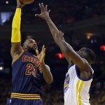 Cleveland Cavaliers forward LeBron James, left, shoots against Golden State Warriors forward Draymond Green during the first half of Game 5 of basketball's NBA Finals in Oakland, Calif., Sunday, June 14, 2015. (AP Photo/Ben Margot)
