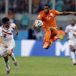 Netherlands' Jeremain Lens leaps to stop a pass next to Costa Rica's Johnny Acosta during the World Cup quarterfinal soccer match at the Arena Fonte Nova in Salvador, Brazil, Saturday, July 5, 2014. (AP Photo/Natacha Pisarenko)