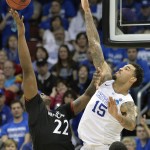 Kentucky's Willie Cauley-Stein, right, attempts to block the shot of Cincinnati's Coreontae DeBerry during the second half of an NCAA tournament college basketball game in Louisville, Ky., Saturday, March 21, 2015. (AP Photo/Timothy D. Easley)