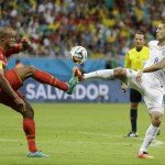 Belgium's Vincent Kompany tries to clear the ball with United States' Clint Dempsey during the World Cup round of 16 soccer match between Belgium and the USA at the Arena Fonte Nova in Salvador, Brazil, Tuesday, July 1, 2014. (AP Photo/Natacha Pisarenko)
