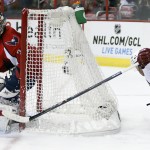 Arizona Coyotes center Sam Gagner (9) reaches around to shoot the puck and his shot is blocked by Washington Capitals goalie Justin Peters (35) in the second period of an NHL hockey game, Sunday, Nov. 2, 2014, in Washington. (AP Photo/Alex Brandon)