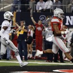 Ohio State's Ezekiel Elliott runs past Oregon's Taylor Alie for a touchdown during the first half of the NCAA college football playoff championship game Monday, Jan. 12, 2015, in Arlington, Texas. (AP Photo/Brandon Wade)