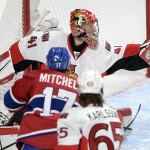Ottawa Senators goalie Craig Anderson (41) makes a glove save on Montreal Canadiens center Torrey Mitchell (17) during the first period of Game 5 of a first-round NHL hockey playoff series, Friday, April 24, 2015, in Montreal. (Ryan Remiorz/The Canadian Press via AP)
