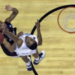 North Carolina forward Brice Johnson, right, blocks a shot by Harvard guard Siyani Chambers during the second half of an NCAA tournament second round college basketball game Thursday, March 19, 2015, in Jacksonville, Fla. (AP Photo/John Raoux)