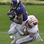 Northwestern wide receiver Kyle Prater (21) is tackled by Wisconsin linebacker Marcus Trotter (59) during the first half of an NCAA college football game in Evanston, Ill., Saturday, Oct. 4, 2014. (AP Photo/Nam Y. Huh)