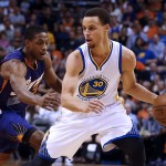 Golden State Warriors guard Stephen Curry (30) shields the ball from Phoenix Suns guard Brandon Knight in the second quarter during an NBA basketball game, Monday, March 9, 2015, in Phoenix. (AP Photo/Rick Scuteri)