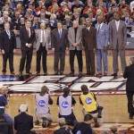 Naismith Memorial Hall of Fame President and CEO John Doleva, from left, Jerry Colangelo and Naismith Memorial Basketball Hall of Fame class of 2015 members, NBA referee Dick Bavetta, Kentucky coach John Calipari, former ABA player Louie Dampier, former NBA player Jo Jo White, former NBA player Spencer Haywood and former NBA player Dikembe Mutumbo are introduced during the second half of the NCAA Final Four college basketball tournament championship game between Wisconsin and Duke Monday, April 6, 2015, in Indianapolis. (AP Photo/Darron Cummings)