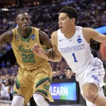 Kentucky's Devin Booker (1) drives on Notre Dame's Jerian Grant (22) during the first half of a college basketball game in the NCAA men's tournament regional finals, Saturday, March 28, 2015, in Cleveland. (AP Photo/David Richard)