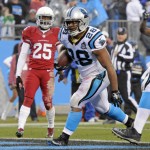Carolina Panthers' Jonathan Stewart (28) runs into the end zone for a touchdown past Arizona Cardinals' Jerraud Powers (25) in the first half of an NFL wild card playoff football game in Charlotte, N.C., Saturday, Jan. 3, 2015. (AP Photo/Mike McCarn)