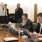 Green Bay Packers director of player personnel Eliot Wolf, second from right, talks on the phone as general manager Ted Thompson, president Mark Murphy and head coach Mike McCarthy visit with each other inside the war room during the NFL Draft at Lambeau Field in Green Bay, Wis., on Thursday, April 30, 2015. Also shown is Brian Gutekunst, director of college scouting. (Evan Siegle/The Green Bay Press-Gazette via AP