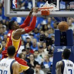 Houston Rockets' Dwight Howard, top left, dunks as Dallas Mavericks' Al-Farouq Aminu, right, watches in the second half of Game 3 in an NBA basketball first-round playoff series Friday, April 24, 2015, in Dallas. The Rockets won 130-128. (AP Photo/Tony Gutierrez)