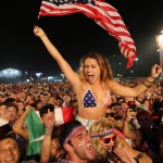 Soccer fans of the U.S. national soccer team cheer minutes before a live broadcast of the soccer World Cup match between USA and Ghana, inside the FIFA Fan Fest area on Copacabana beach, Rio de Janeiro, Brazil, Monday, June 16, 2014. (AP Photo/Leo Correa)