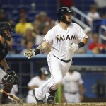  Miami Marlins's Jarrod Saltalamacchia hits into a double play in front of Arizona Diamondbacks catcher Tuffy Gosewisch to end the first inning of a baseball game in Miami, Friday, Aug. 15, 2014. (AP Photo/J Pat Carter)
