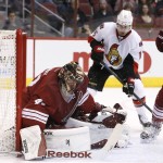 Ottawa Senators' Clarke MacArthur (16) waits for a rebound on an initial save by Arizona Coyotes' Mike Smith, left, but the puck bounces past Coyotes' Chris Summers (20) and MacArthur would send the puck into the net for a goal during the first period of an NHL hockey game Saturday, Jan. 10, 2015, in Glendale, Ariz. (AP Photo/Ross D. Franklin)